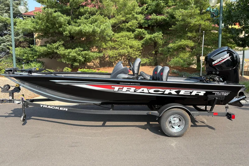 The Image of 2026 Tracker Pro Team 175 Crappie Edition boat on trailer, parked outdoors. - 0