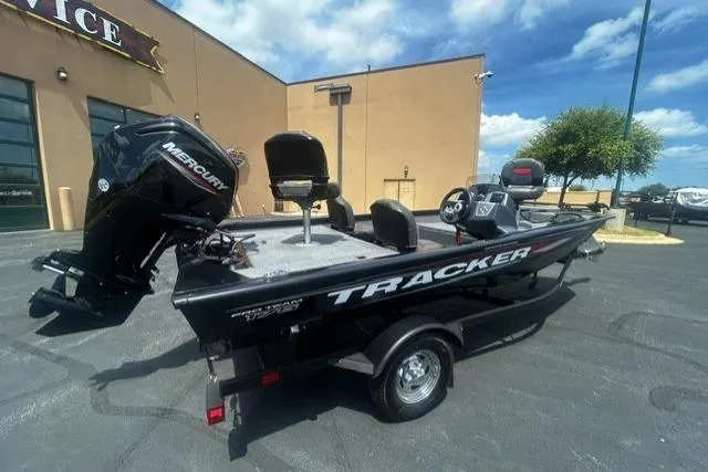 Slide: The Image of 2026 Tracker Pro Team 175 Crappie Edition boat with Mercury engine, parked outdoors. - 3