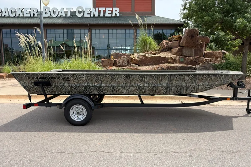 Slide: The Image of 2026 Tracker Grizzly 1860 Utility boat on trailer outside Tracker Boat Center. - 5