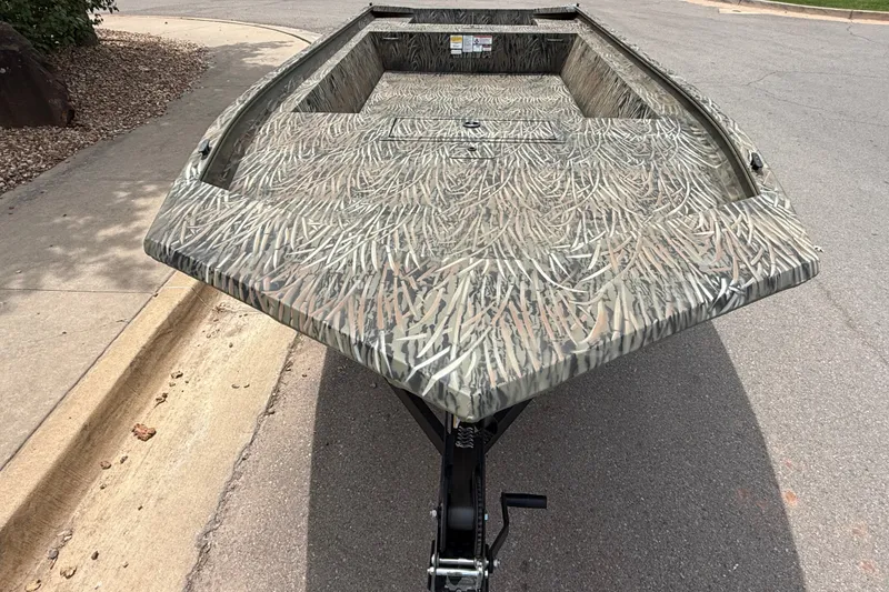 Slide: The Image of 2026 Tracker Grizzly 1860 Utility boat with camouflage pattern on a trailer. - 2