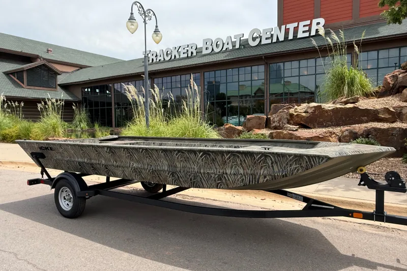 Slide: The Image of 2026 Tracker Grizzly 1860 Utility boat on trailer outside Tracker Boat Center. - 6