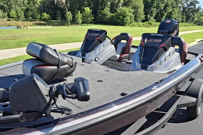 Slide: The Image of 2026 Nitro Z18 Pro boat with Garmin equipment, parked on a trailer in a scenic park setting. - 2