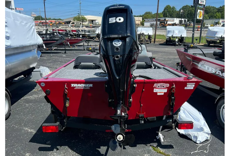 Slide: The Image of 2026 Tracker Bass Tracker Classic XL boat with Mercury 50 engine, parked outdoors. - 10