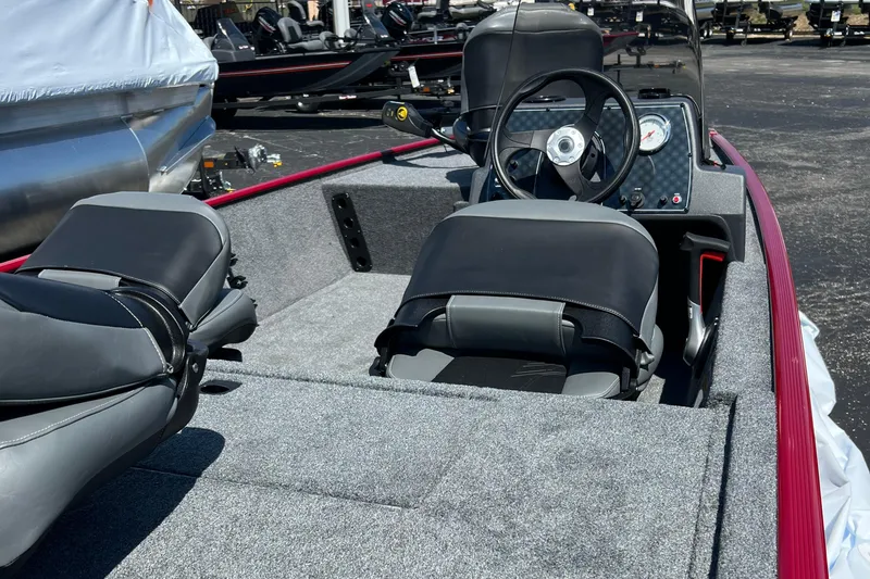 Slide: The Image of 2026 Tracker Bass Tracker Classic XL boat interior with steering wheel and seating. - 7
