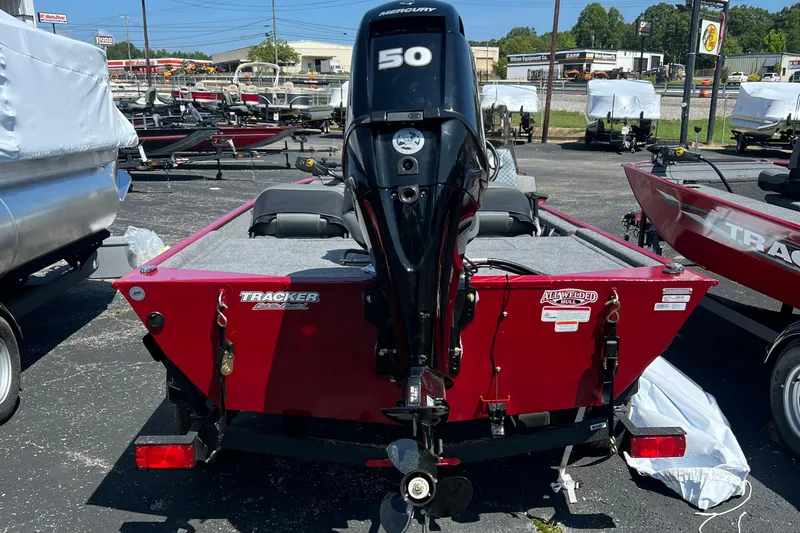 Slide: The Image of 2026 Tracker Bass Tracker Classic XL boat with Mercury 50 engine, parked outdoors. - 8