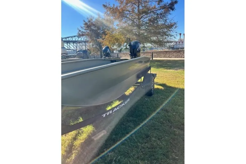 Slide: The Image of 2026 Tracker Grizzly 1650 T Prairie Wings Edition boat on grassy area, sunny day. - 35