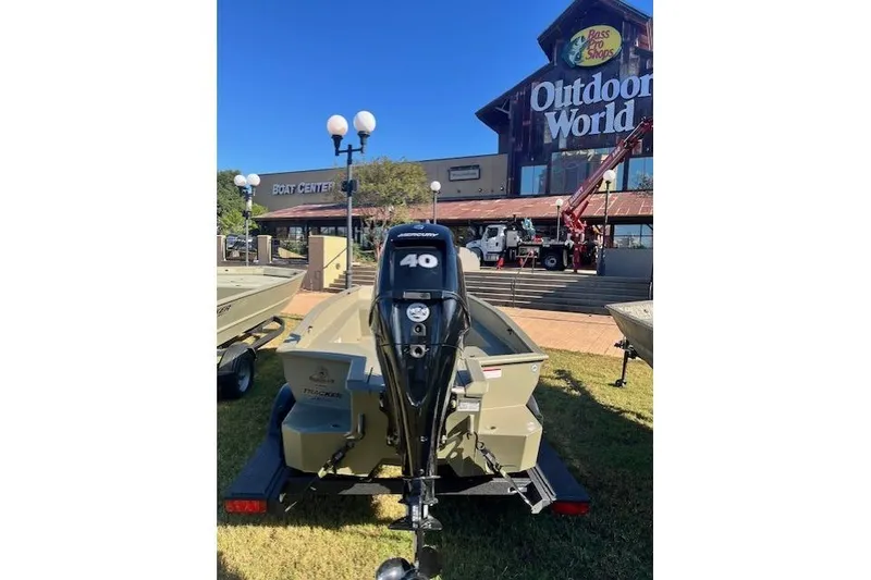 Slide: The Image of 2026 Tracker Grizzly 1650 T Prairie Wings Edition boat at outdoor store display. - 36