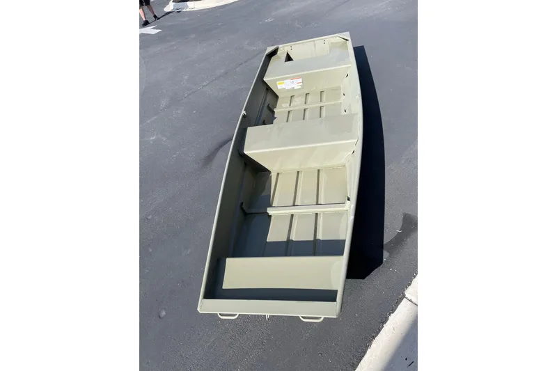 The Image of 2026 Tracker Grizzly 14 Jon boat on pavement, showcasing interior layout and design. - 0