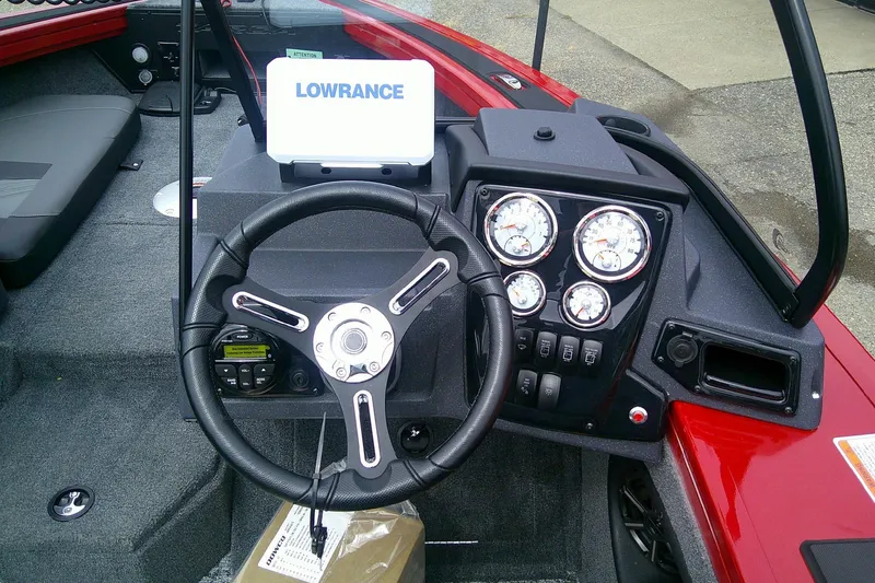 Slide: The Image of 2026 Tracker Targa V-18 Combo boat dashboard with steering wheel and Lowrance display. - 10