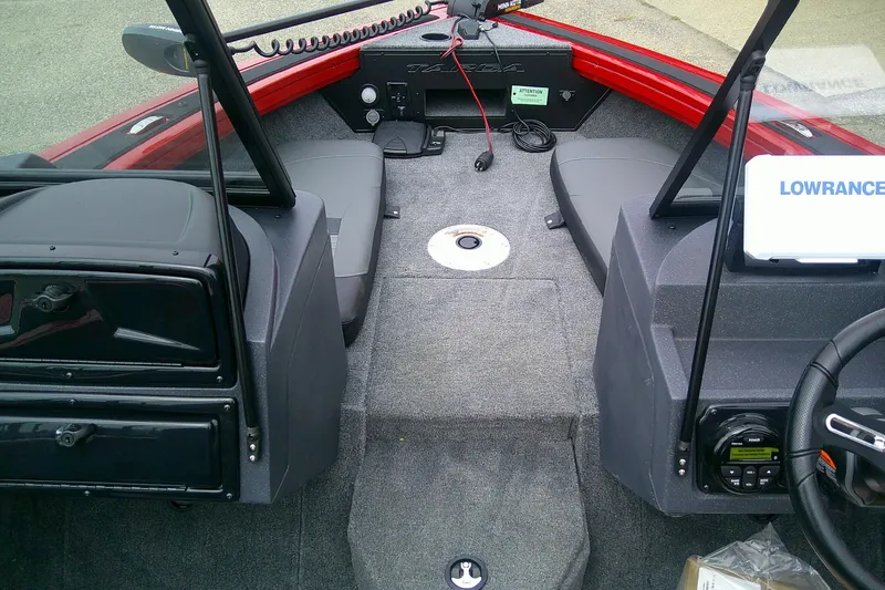 Slide: The Image of 2026 Tracker Targa V-18 Combo boat interior with Lowrance electronics and seating. - 12