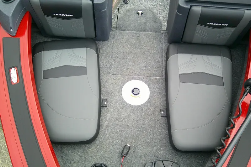 Slide: The Image of 2026 Tracker Targa V-18 Combo boat interior with gray seats and red accents. - 14