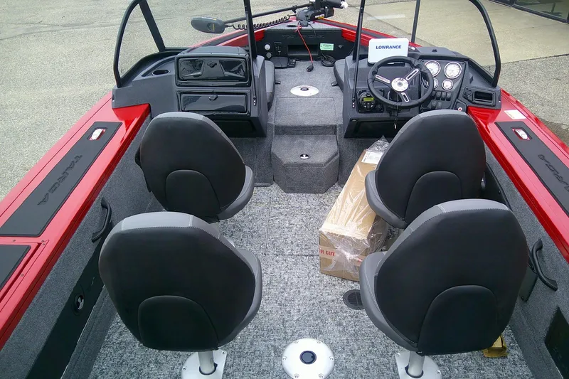 Slide: The Image of 2026 Tracker Targa V-18 Combo boat interior with seating and control panel. - 6