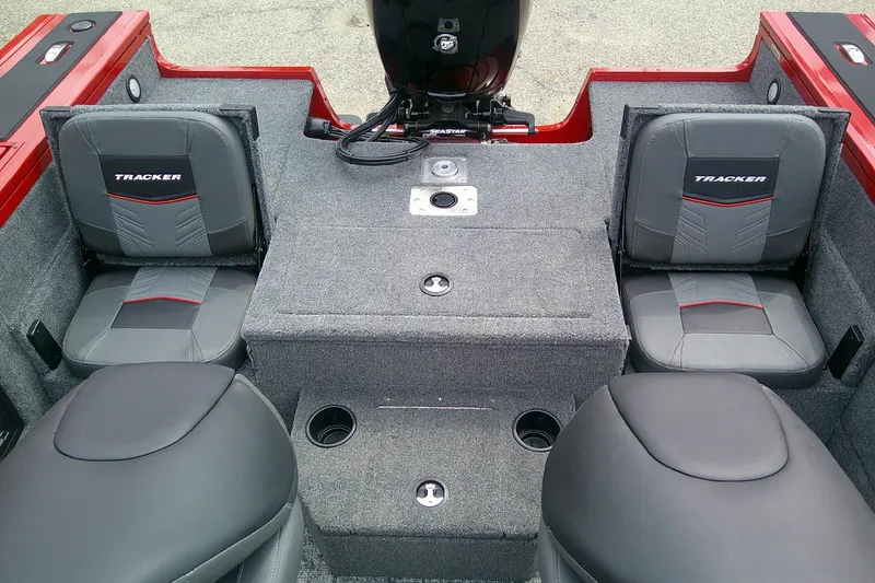 Slide: The Image of 2026 Tracker Targa V-18 Combo boat interior with gray seating and red accents. - 9