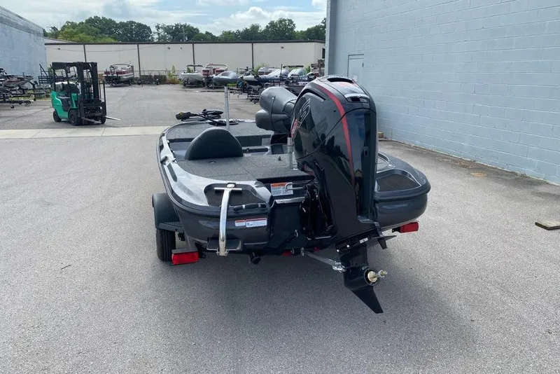 Slide: The Image of 2026 Nitro Z17 boat with outboard motor on trailer, parked outdoors. - 97
