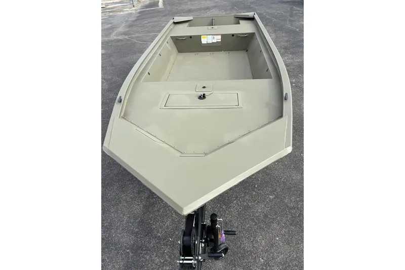 Slide: The Image of 2026 Tracker Grizzly 1648 Utility boat on pavement, showcasing spacious interior design. - 2