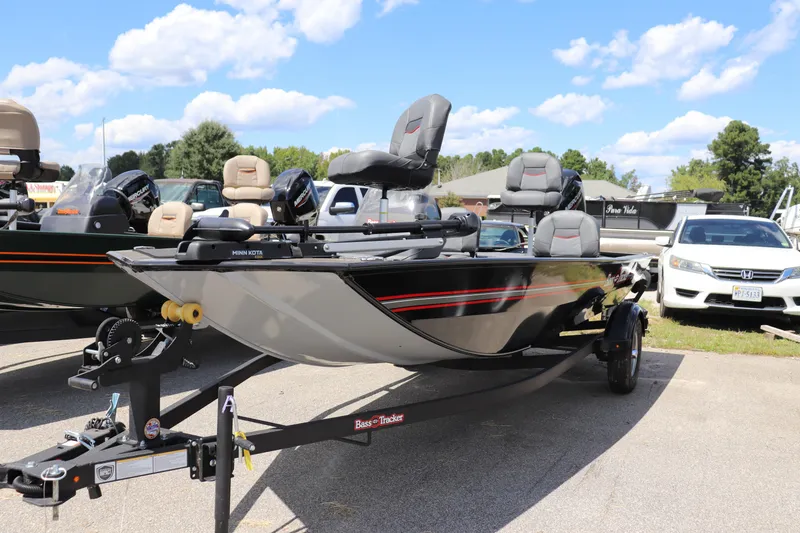 The Image of 2026 Tracker Bass Tracker Classic XL boat on trailer, parked outdoors under blue sky. - 0