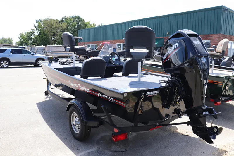 Slide: The Image of 2026 Tracker Bass Tracker Classic XL boat with Mercury engine in a dealership lot. - 12
