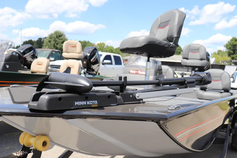 Slide: The Image of 2026 Tracker Bass Tracker Classic XL boat with Minn Kota trolling motor, parked outdoors. - 2