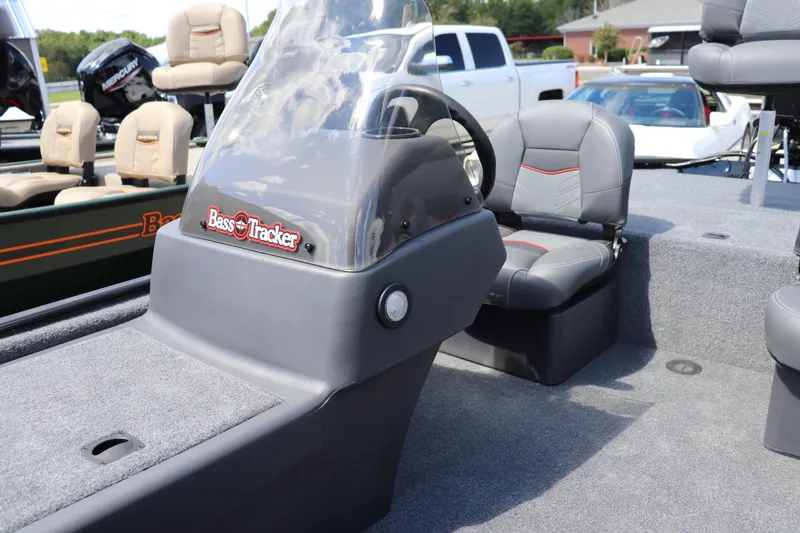 Slide: The Image of 2026 Tracker Bass Tracker Classic XL boat interior with steering console and seating. - 6