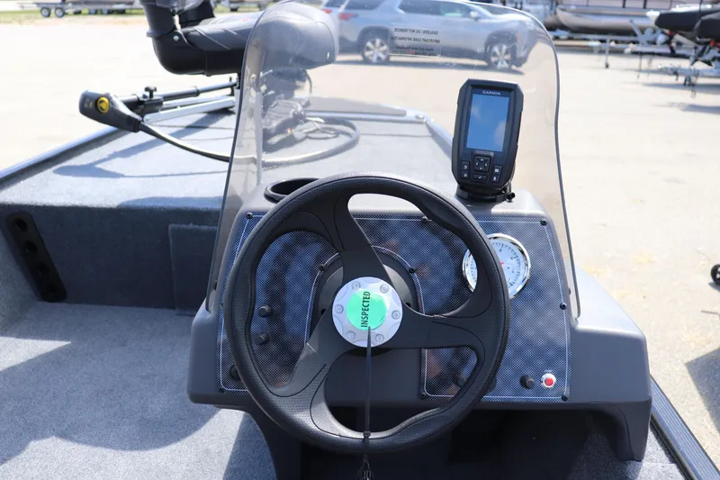 Slide: The Image of 2026 Tracker Bass Tracker Classic XL dashboard with steering wheel and fish finder. - 7
