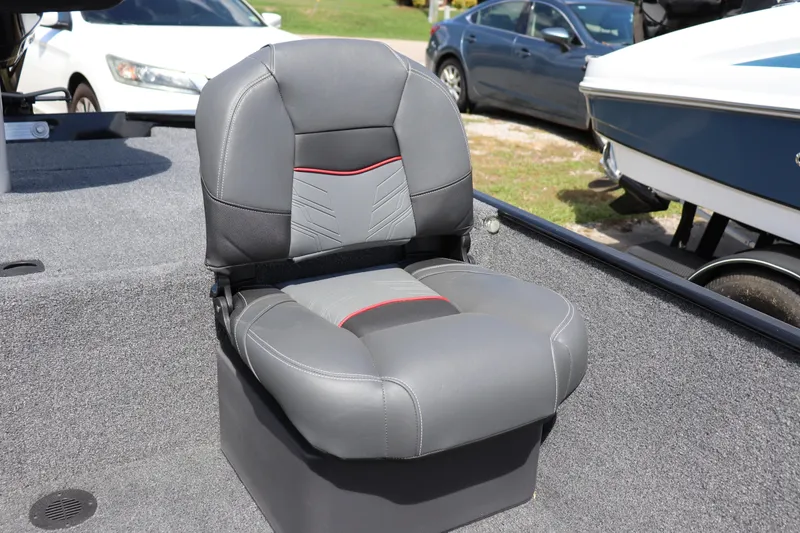 Slide: The Image of 2026 Tracker Bass Tracker Classic XL boat seat, gray with red accents, on deck. - 8