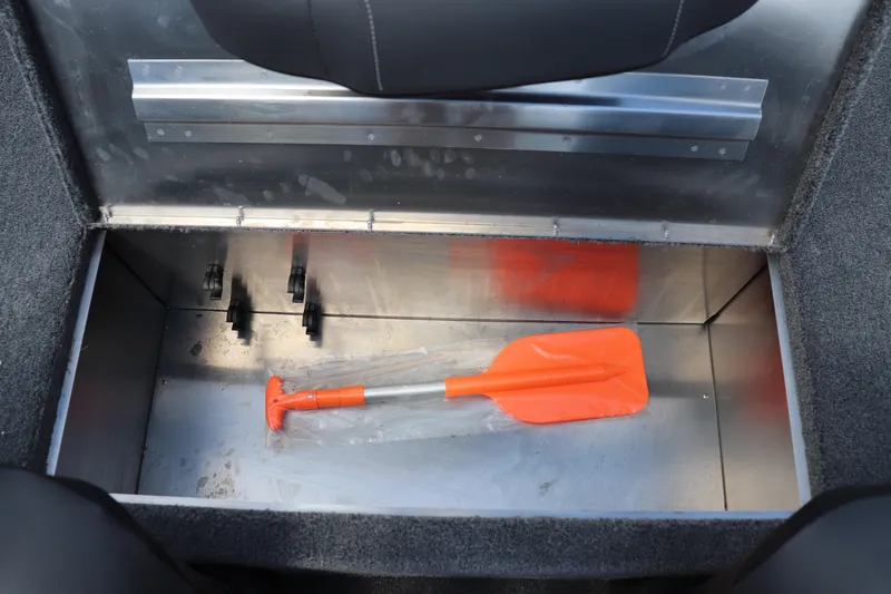 Slide: The Image of Storage compartment in 2026 Tracker Bass Tracker Classic XL with orange paddle. - 9