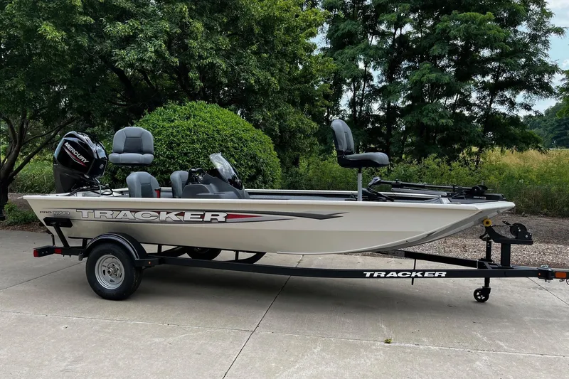 The Image of 2026 Tracker Pro 170 boat on trailer, parked outdoors with lush greenery background. - 0