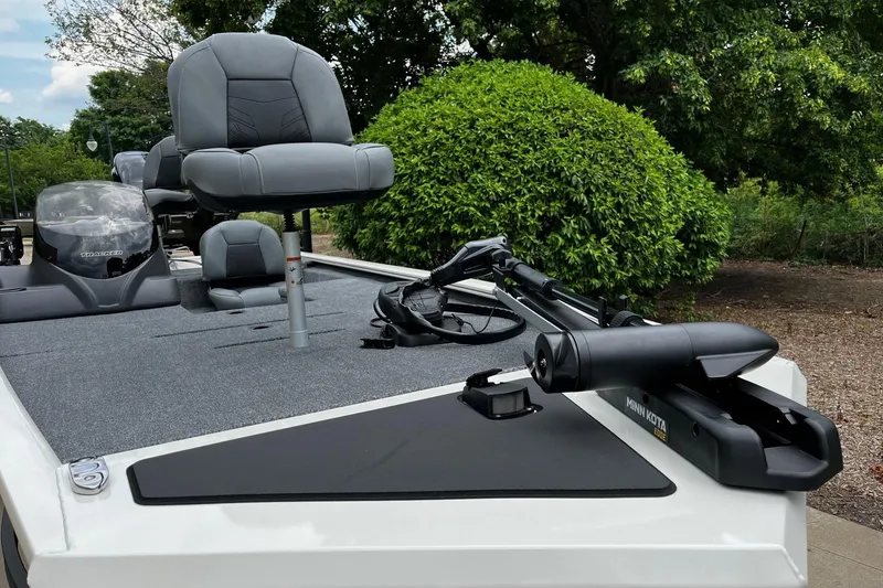 Slide: The Image of 2026 Tracker Pro 170 boat with seating and Minn Kota trolling motor, surrounded by greenery. - 3