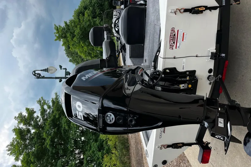Slide: The Image of 2026 Tracker Pro 170 boat with Mercury outboard motor, parked outdoors. - 4