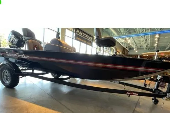 The Image of 2026 Tracker Bass Tracker Classic XL boat displayed indoors on a trailer. - 0