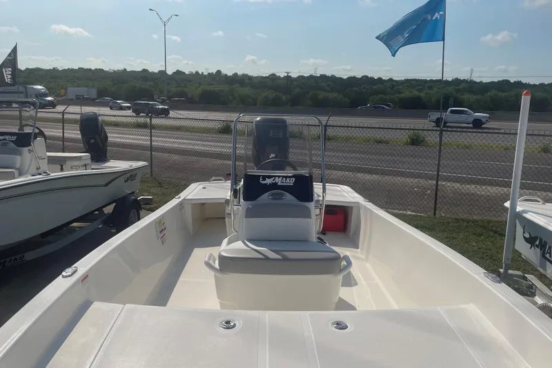 Slide: The Image of 2026 Mako Pro Skiff 17 CC boat displayed outdoors near highway. - 10