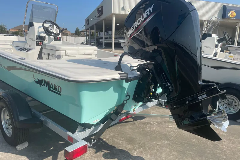 Slide: The Image of 2026 Mako Pro Skiff 17 CC boat with Mercury outboard motor on trailer. - 3