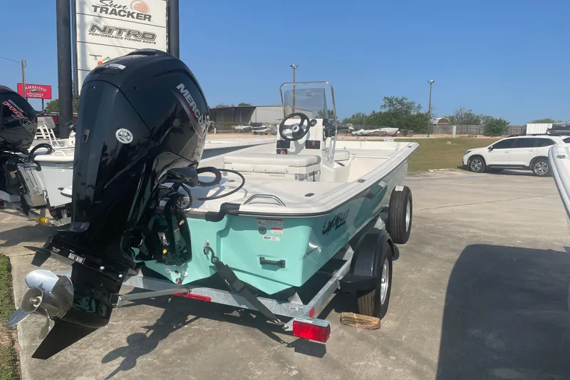 Slide: The Image of 2026 Mako Pro Skiff 17 CC boat with Mercury engine on trailer. - 5