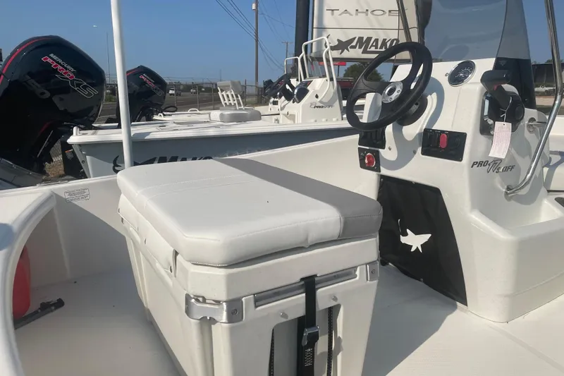 Slide: The Image of 2026 Mako Pro Skiff 17 CC boat interior with steering console and seating. - 7