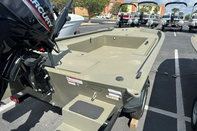 Slide: The Image of 2026 Tracker Grizzly 1654 T Sportsman boat with Mercury engine in a parking lot. - 8