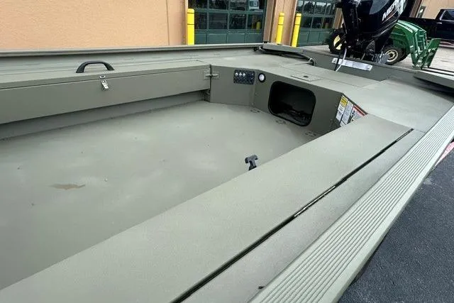 Slide: The Image of 2026 Tracker Grizzly 1654 T Sportsman boat interior, showcasing spacious deck and storage compartments. - 4