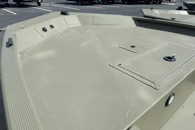 Slide: The Image of 2026 Tracker Grizzly 1654 T Sportsman boat deck, featuring storage compartments and control panels. - 11