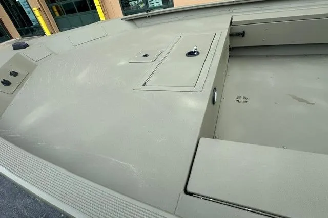 Slide: The Image of 2026 Tracker Grizzly 1654 T Sportsman boat deck with storage compartments. - 3