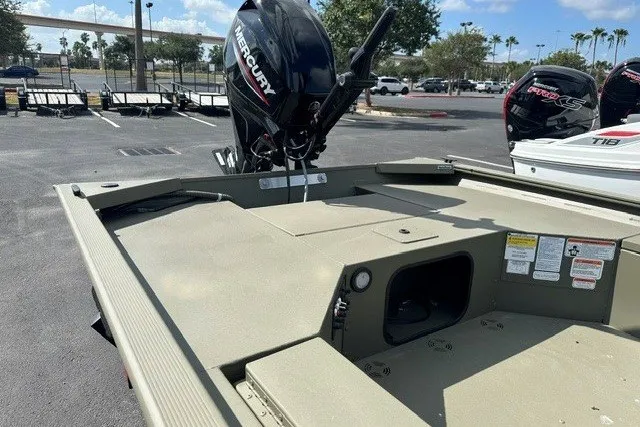 Slide: The Image of 2026 Tracker Grizzly 1654 T Sportsman boat with Mercury engine in parking lot. - 7