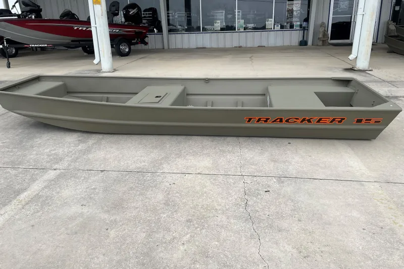 Slide: The Image of 2026 Tracker Grizzly 15 Jon boat in showroom, side view, olive green color. - 2