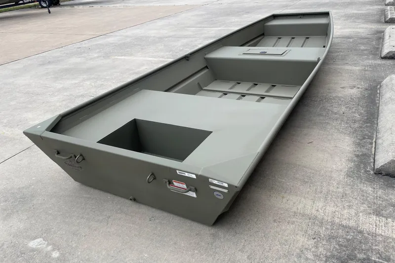 Slide: The Image of 2026 Tracker Grizzly 15 Jon boat on concrete surface, showcasing its durable design. - 4