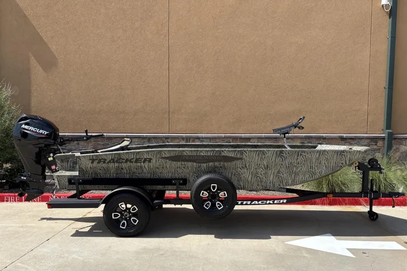 Slide: The Image of 2026 Tracker Grizzly 1650 T Prairie Wings Edition boat on trailer, side view. - 3