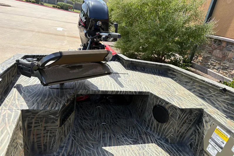 Slide: The Image of 2026 Tracker Grizzly 1650 T Prairie Wings Edition boat with camouflage interior and motor. - 4