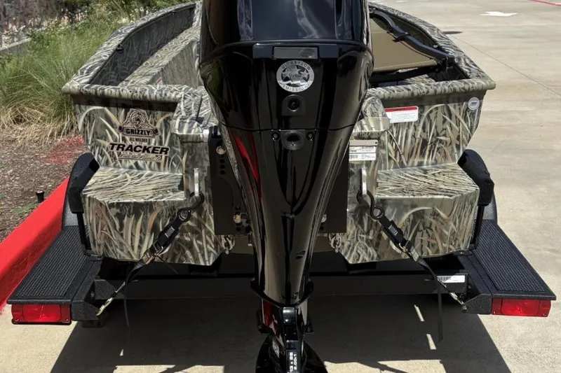 Slide: The Image of 2026 Tracker Grizzly 1650 T Prairie Wings Edition boat with camouflage design on trailer. - 5