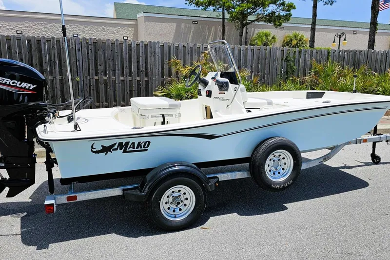 Slide: The Image of 2026 Mako Pro Skiff 15 CC boat on trailer, featuring Mercury outboard motor. - 1
