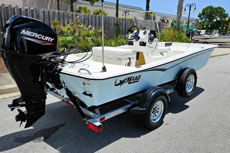 Slide: The Image of 2026 Mako Pro Skiff 15 CC boat on trailer with Mercury outboard motor. - 2