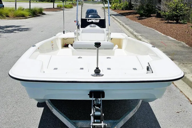 Slide: The Image of 2026 Mako Pro Skiff 15 CC boat on trailer, parked on a sunny street. - 6