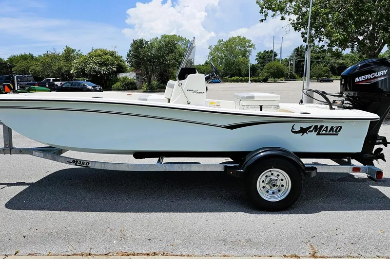 Slide: The Image of 2026 Mako Pro Skiff 15 CC boat on trailer, parked outdoors. - 8