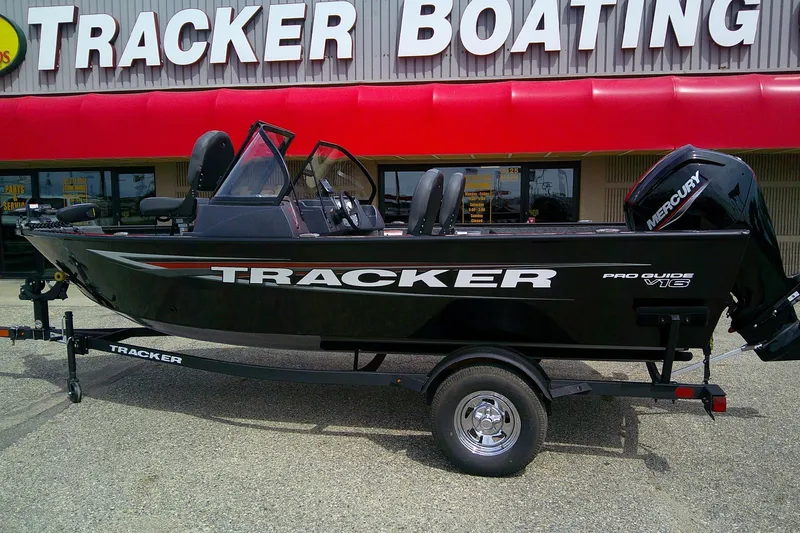 Slide: The Image of 2026 Tracker Pro Guide V-16 WT boat displayed at Tracker Boating store. - 2
