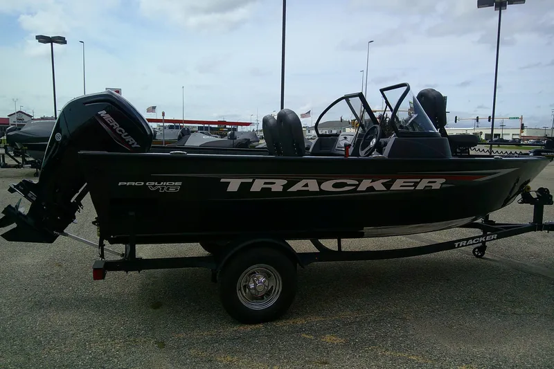 Slide: The Image of 2026 Tracker Pro Guide V-16 WT boat on trailer in parking lot. - 3